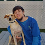 kacper-holding-dog_338x600