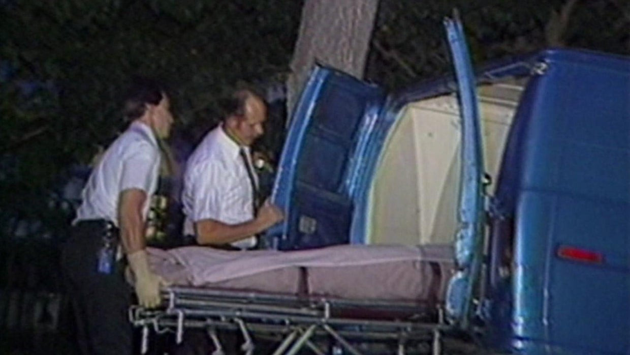 First responders carrying the bodies of Jose and Kitty Menendez outside the crime scene