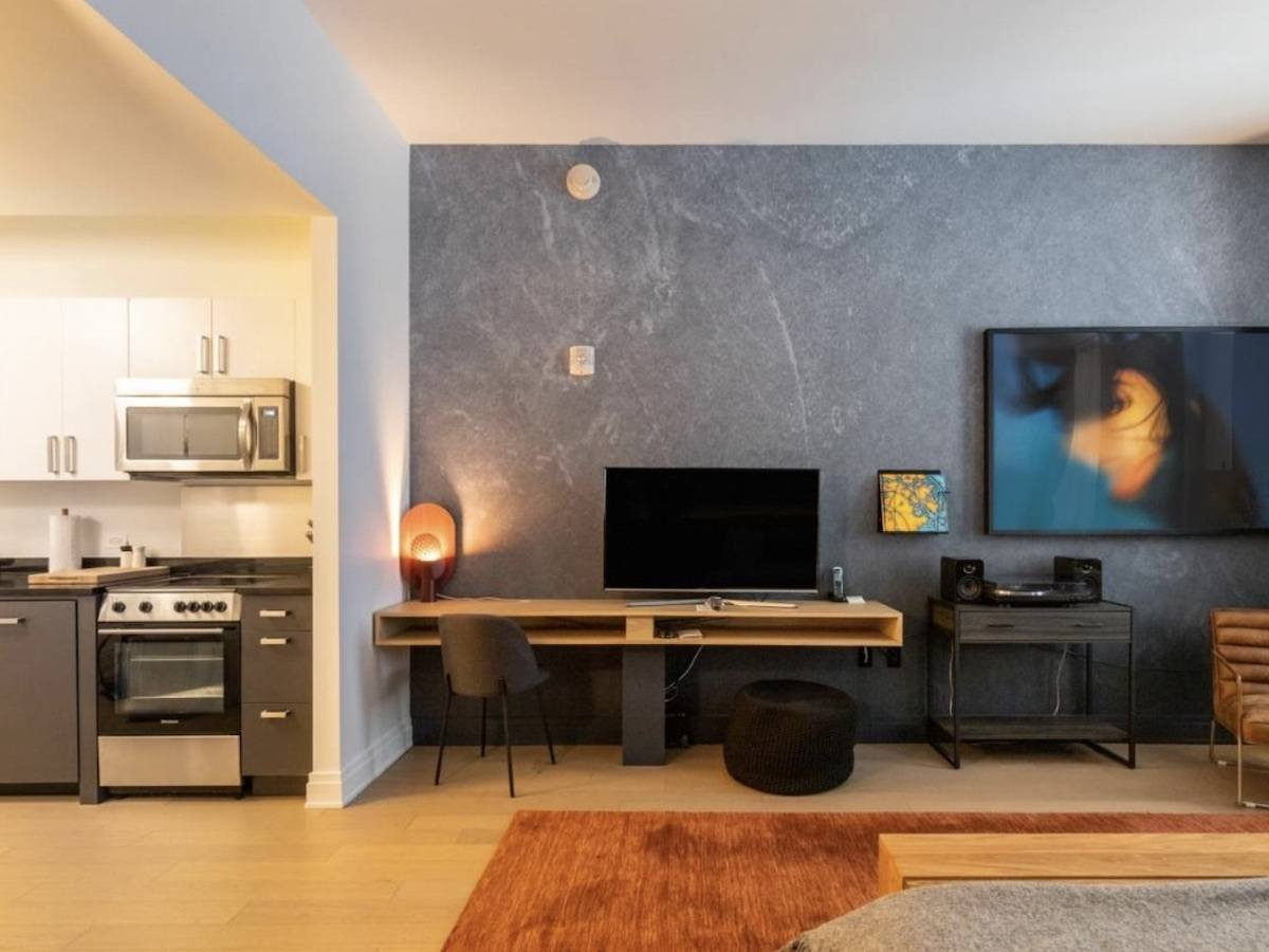 Mint House at 70 Pine Family Suite Alt Text: A stylish and comfortable living area in a family suite at Mint House at 70 Pine, offering a modern and historic blend in NYC's Financial District.