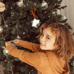boy decorating christmas tree