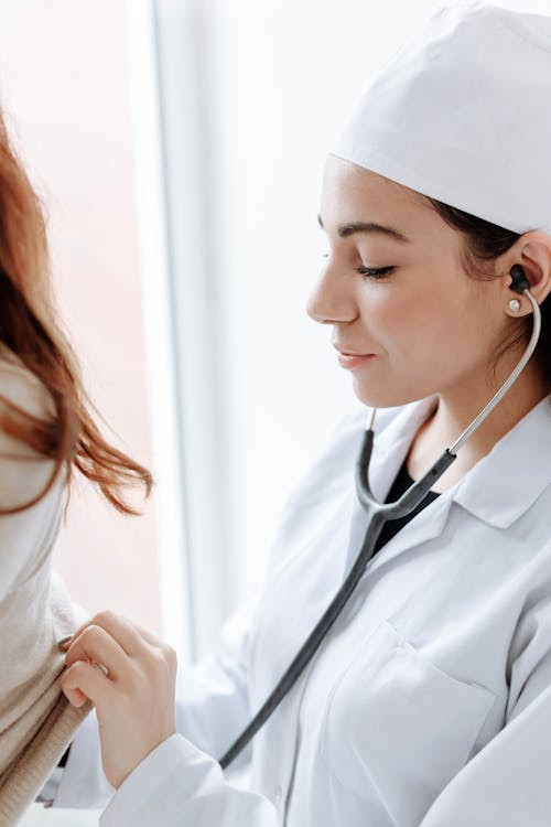 A doctor talking to a patient and taking notes during a consultation at a family medical center